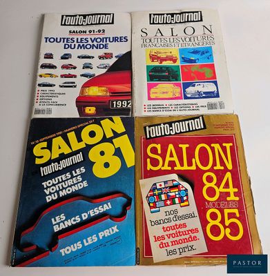 four books on a white table with a red car in front of them