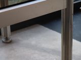 a close up of a glass door with a metal pole