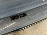 a sticker that says caution on the back of a car