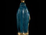 a statue of the virgin of guadalupe in blue and gold on a black background