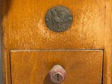 a small wooden box with a clock on top of it