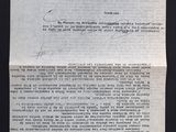 a close up of a piece of paper on a black surface