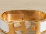 gold and white enamel bangle bracelet with h monograms