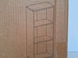 an open cardboard box with a drawing of a tall bookcase