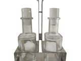 two glasses and a spoon sitting on a glass holder