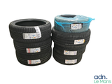 several tires stacked on top of each other on a white surface
