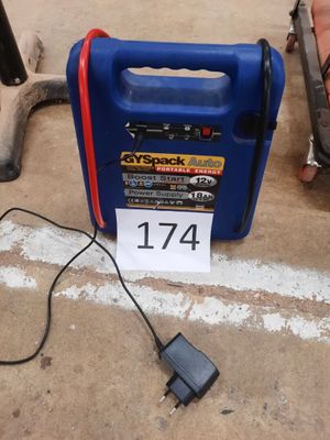 a blue portable air compressor sitting on the ground