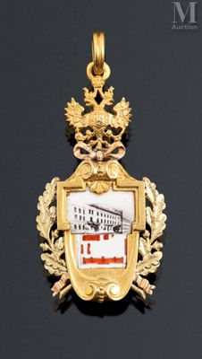 an image of a gold pendant with a picture of a ship on it