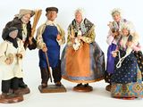 five figurines of people dressed in traditional clothing