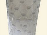 a clear glass with a pattern on it on a white surface