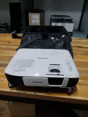 a projector sitting on top of a wooden table
