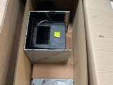 a box with a computer inside of it sitting on a carton