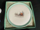 a plate that has a picture of a horse drawn carriage on it