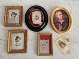 many framed pictures of women and men on the wall