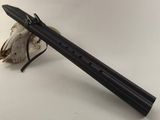 a black flute with a skull on the side of it