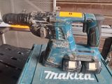 a blue corded drill that is sitting on a table