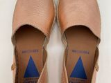 the shoes are tan and blue with a blue triangle on them