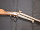 an old gun with a wooden handle on a black background