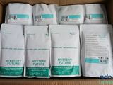 several bags of mystery future coffee sit in a cardboard box
