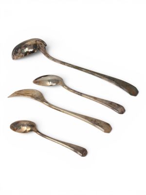 four spoons and a spoon rest on a white surface