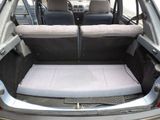 the back of a car with its trunk open and seats folded down