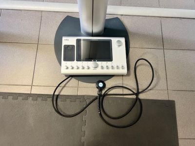 a machine that is sitting on the floor next to a laptop