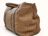an image of a handbag made of woven leather