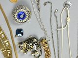 many different types of necklaces and bracelets on the table