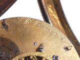a close up of a gold clock with a white background