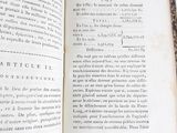 an open book on a white surface with a green border