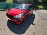 a picture of a red car parked on the side of the road