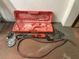 a red case with tools in it sitting on the floor