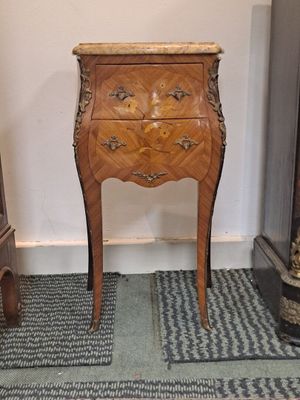 a small wooden table with a clock on top of it