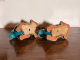 pair of orange and blue fish figurines sitting on a wooden table