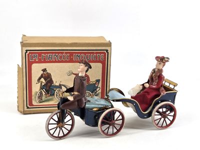 toy figurines of a man and a woman in a carriage