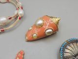 three necklaces that are sitting on a table