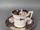 a close up of a cup and saucer on a table