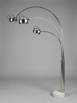 a chrome and marble floor lamp with three spheres on a marble base