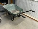 a wheelbarrow in the middle of a dirty room