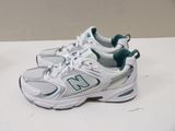 a pair of new balance running shoes on a table