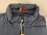 the jacket is blue and has a brown tag on it