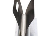 a pair of scissors sitting on top of a piece of metal