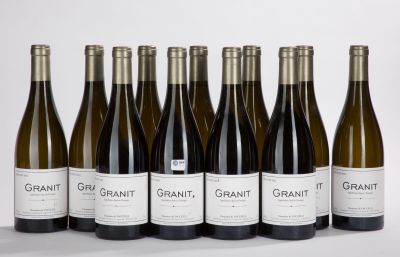 six bottles of wine are lined up in a row on a white surface