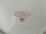 a white plate with a red and black design on it