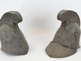 these are two statues of a bird on a white background