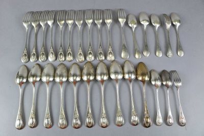 a lot of silver spoons and forks laid out on a table