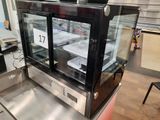 a display case with a lot of food inside of it