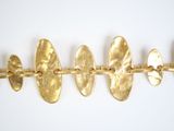a close up of a row of gold plated bracelets on a white background