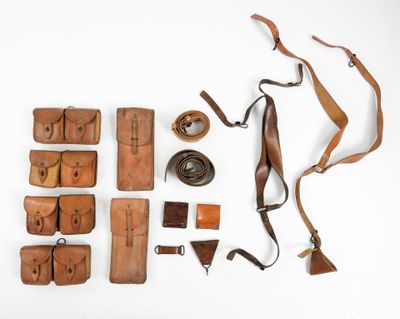 a lot of leather items laid out on a white surface