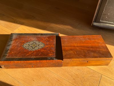 a small wooden box sitting on a wooden floor